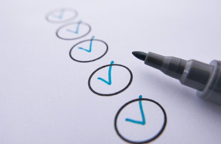 A Marker Near Checked Circles on White Paper