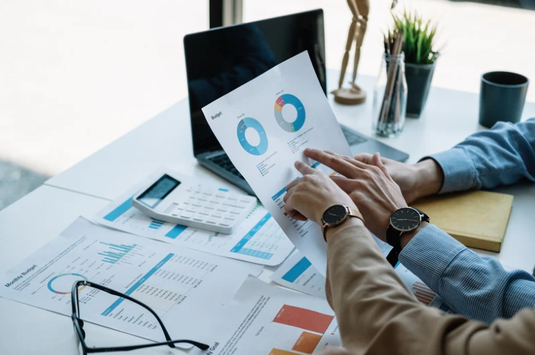 two accountants sharing calculations about company’s finances and budget planning