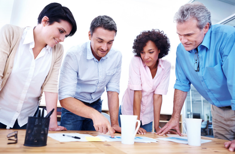 four business people using documentation during a business meeting 
