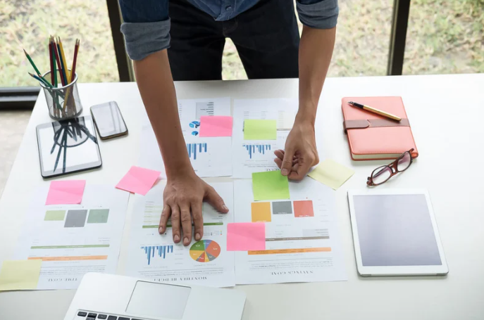 business man studying financial data sheets