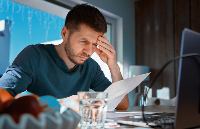businessman looking through paperwork 