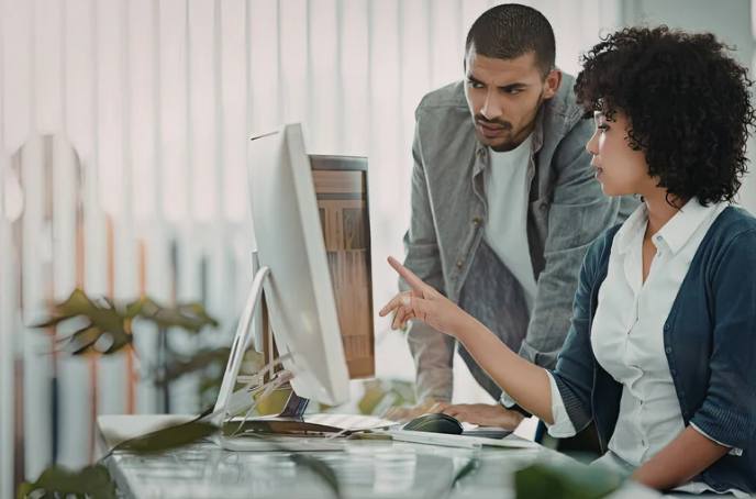 Two people looking at a computer screen together
