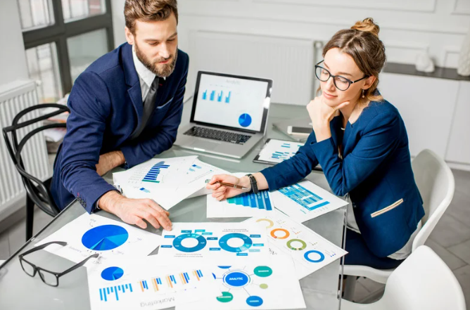 Business people analysing financial charts 