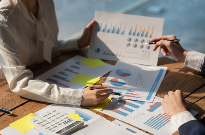 Business People Meeting discussing financial figures 